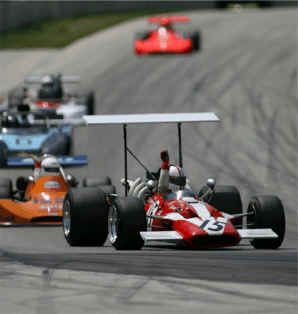 Surtees F/5000 with vintage AP brakes leads the field to the flag at Road America